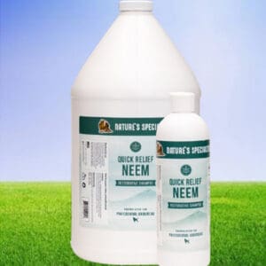 A bottle of neem oil next to a container.
