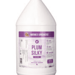 A gallon of purple liquid is sitting on the floor.